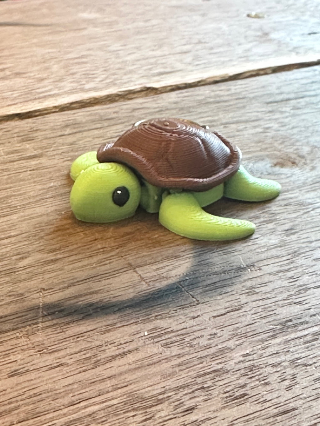 Small turtle figurine on a wooden surface
