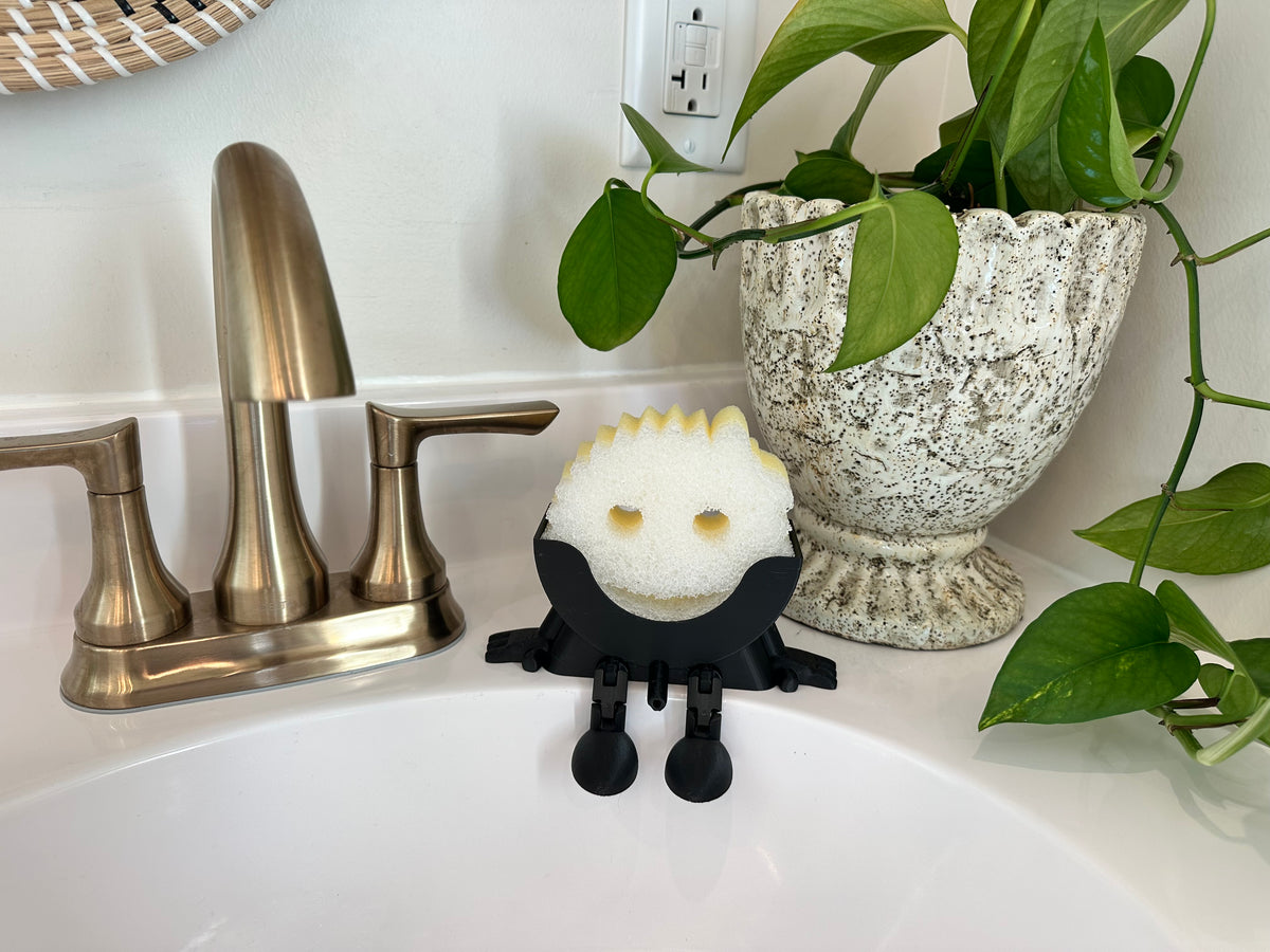 Little Dripper sponge holder holding a scrubber in kitchen sink